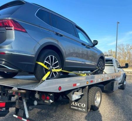 Tow truck helping a stranded driver in bad weather.