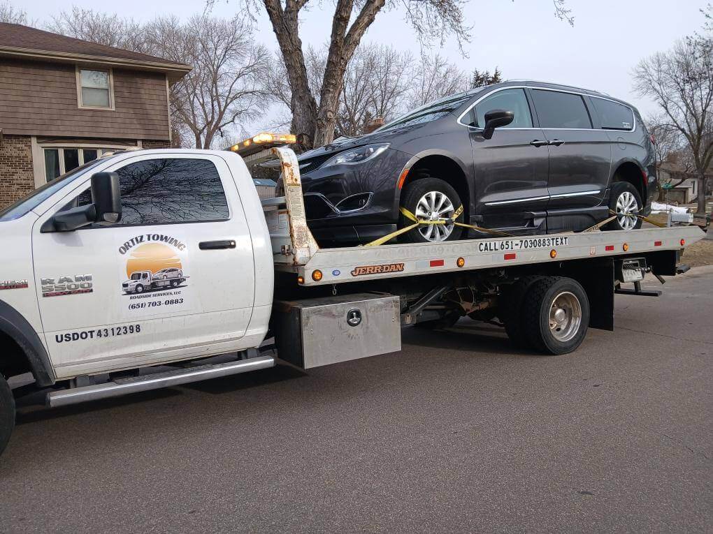 Tow truck assisting a driver in a busy street.