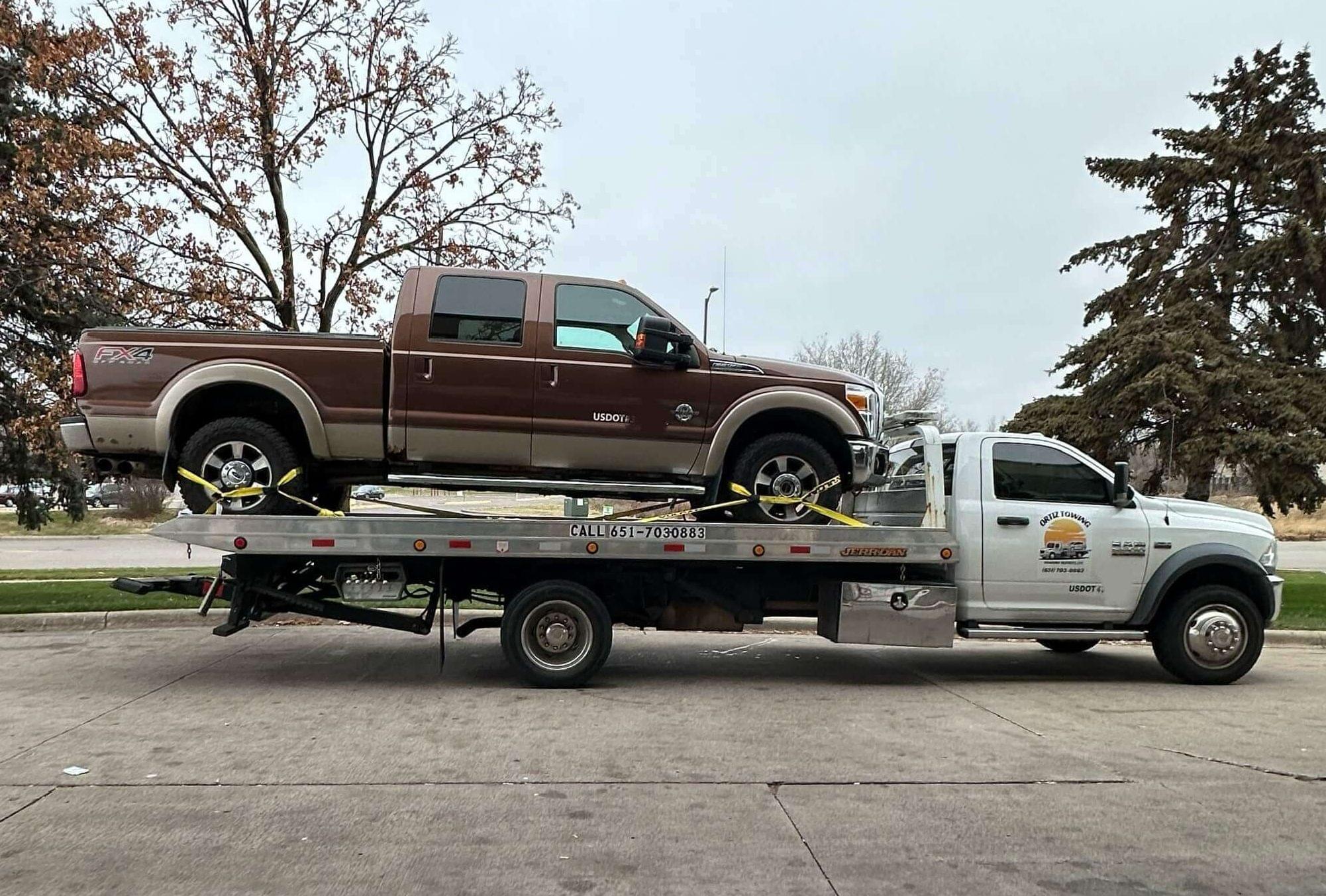 Reliable St Paul towing service assisting a stranded vehicle on the roadside.